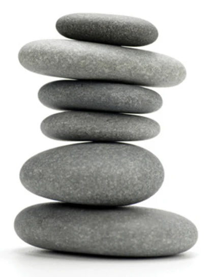 Balanced stack of smooth stones symbolising Sarden Learning structured approach to training philosophy and methodology